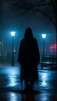 a person in a hooded cloak standing in a park at night generative ai photo