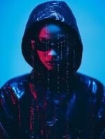 a person wearing a black hoodie and sunglasses in front of a blue background generative ai photo