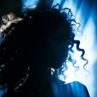 a silhouette of a woman with curly hair generative ai photo