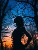 a silhouette of a woman standing in the woods at sunset generative ai photo