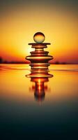 a stack of stones on top of water at sunset generative ai photo