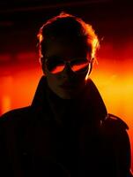 a woman wearing sunglasses and a trench coat in the dark generative ai photo