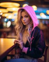 beautiful blonde woman in pink hoodie sitting at a table generative ai photo