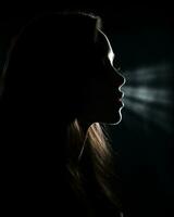 silhouette of a beautiful woman in the dark with light coming from her mouth generative ai photo