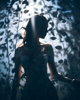 silhouette of a woman in a forest with leaves generative ai photo