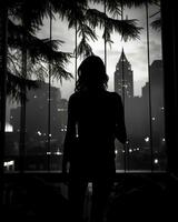 silhouette of a woman standing in front of a window with city lights in the background generative ai photo