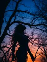 silhouette of a woman standing in front of trees at sunset generative ai photo