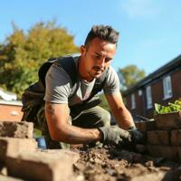 Mason laying bricks to build a wall photo