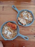 delicious spaghetti served in industrial pan photo