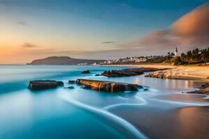 un hermosa playa a puesta de sol con rocas y agua. generado por ai foto