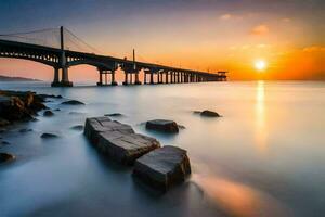 the sun sets over a bridge and rocks in the water. AI-Generated photo