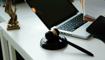 Judge gavel with Justice lawyers having team meeting at law firm in background. Concepts of law. photo