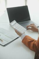 Businessmen are calculating income-expenditure and analyzing real estate investment data, Accounting Financial and tax systems concept. photo