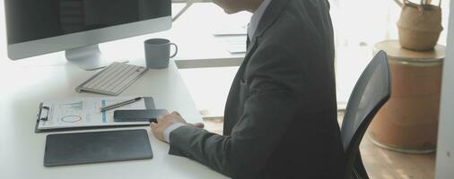 Close up Business woman using calculator and laptop for do math finance on wooden desk, tax, accounting, statistics and analytical research concept photo