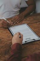 Close up view of job interview in office, focus on resume writing tips, employer reviewing good cv of prepared skilled applicant, recruiter considering application, hr manager making hiring decision photo