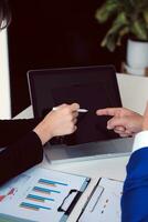 Close up of Business team analyzing income charts and graphs with modern laptop computer. Business analysis and strategy concept. photo