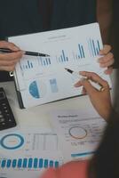 Close up Business woman using calculator and laptop for do math finance on wooden desk, tax, accounting, statistics and analytical research concept photo