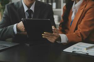 Entrepreneurs and business people conference in modern meeting room, happy multiracial coworkers have fun cooperating working together at office meeting, asian teamwork concept photo