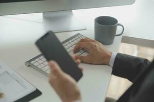 Close up Business woman using calculator and laptop for do math finance on wooden desk, tax, accounting, statistics and analytical research concept photo