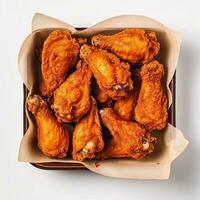 Fried chicken in paper bucket isolated on white background photo