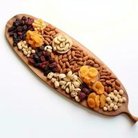 dry fruits in a long wooden platter on a white background topshot photo