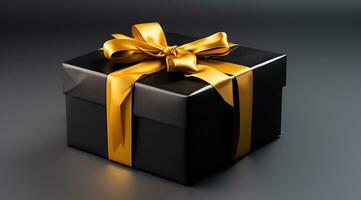 black and gold gift box on a gray background photo