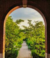 a pathway through a brick archway photo