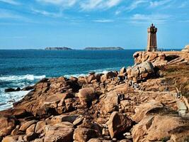 Summer View of Ploumanach Lighthouse and the Sea in Brittany photo