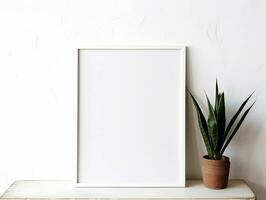 Mock-up of a white frame with a potted plant on a wooden table and a white wall.  AI Generated photo