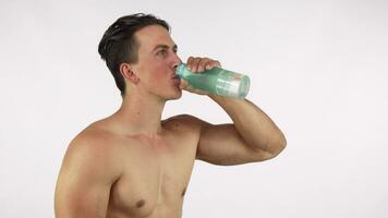 Athletic happy healthy man smiling, drinking water after gym video