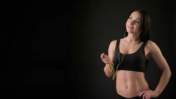 Fitness woman listens to music video