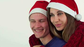 Beautiful happy Christmas couple smiling joyfully, looking away video