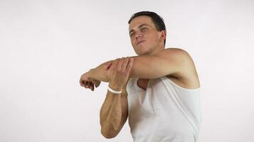 Young man with muscular athletic body warming up before workout video