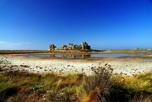 Seaside Serenity Charming Cottage Amidst Rocky Coastline photo