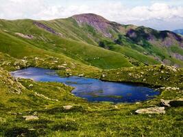 Serene Beauty Mountain Landscape with Small Blue Lake in Saint Sorlin d'Arves, Savoie photo