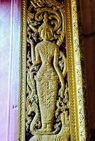 a gold wall decoration with a woman on it photo