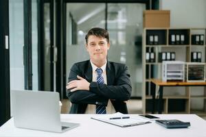 Mature businessman executive manager looking at laptop watching online webinar training or having virtual meeting video conference doing market research working in office. photo