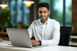 Entrepreneur laptop males happy office happiness technology job young businessman men indian smile sitting photo