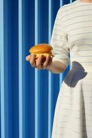 Dinner woman lifestyle art hamburger yellow blue hungry meal fast concept burger hand photo