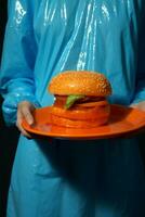 Woman food blue concept delicious fast hand fast yellow burger hamburger young meal art photo