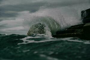 a large wave crashing into the ocean photo