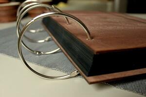 Vintage wood book on the table. Book on a desk. old wooden book. Photoalbum album. ring mechanism for a book photo