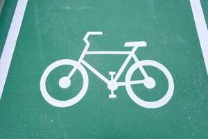 bicycle lane sign green color on the road no people. sport and recreation safety concept background image. sign for travel safety. photo