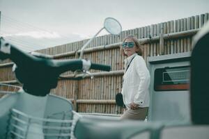 asian woman standing in gas station with female motorcycle forground photo