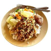 Rice topped with various types of food is called khao topped with curry photo