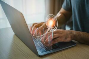 Businessman working with digital laptop and analyzes profitability of virtual candle indecator screen, positive indicators calculates financial data for investments. Business technology target. photo