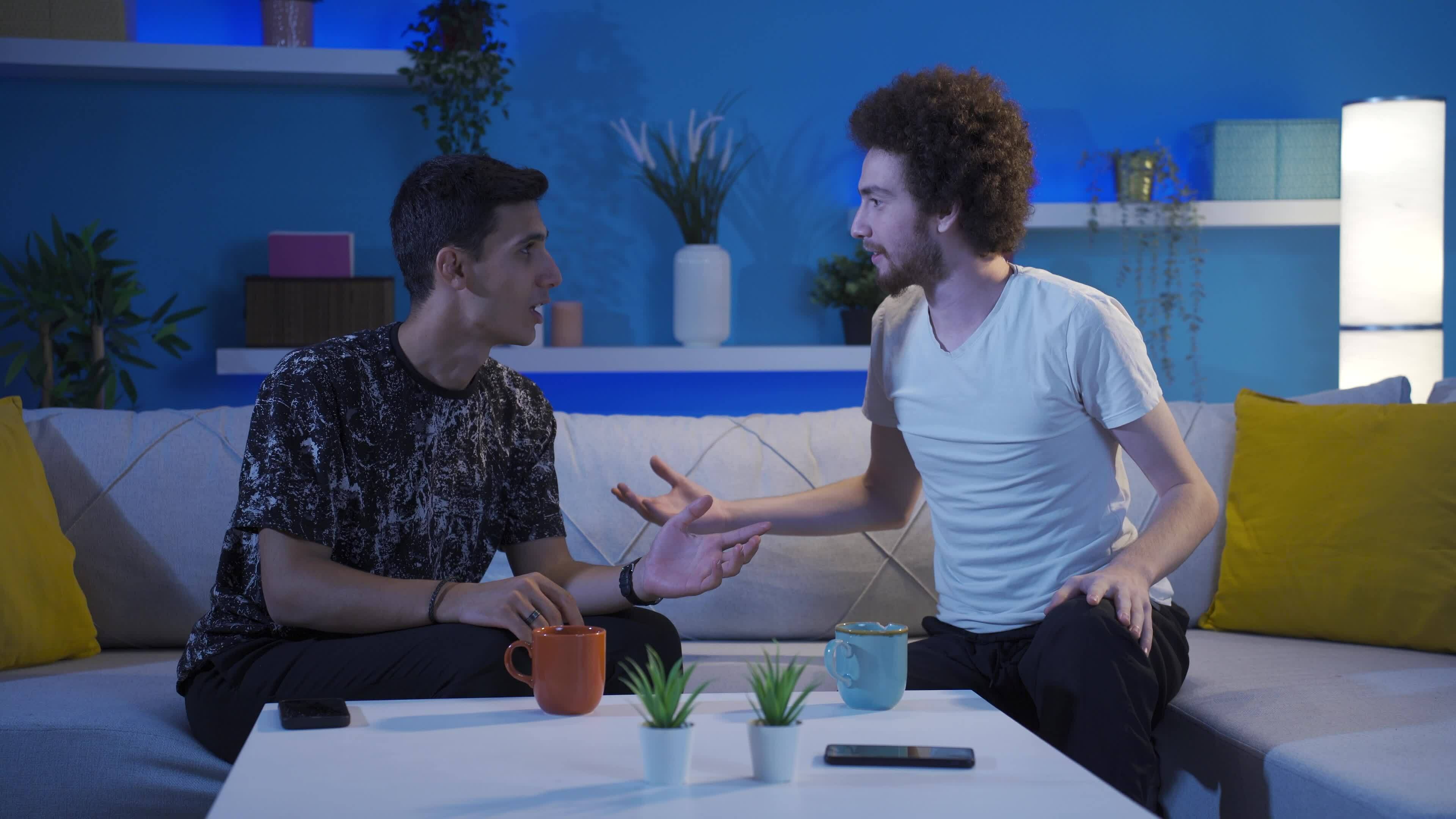 friends-are-arguing-while-drinking-coffee-together-at-home-there-is-a