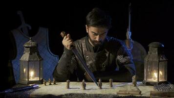 Soldier marking the map with the sword in his hand. video