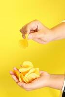Hand with Potato Chips photo