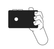 Holding smartphone monochrome flat vector hand. Taking photo. Editable black and white thin line icon. Simple cartoon clip art spot illustration for web graphic design